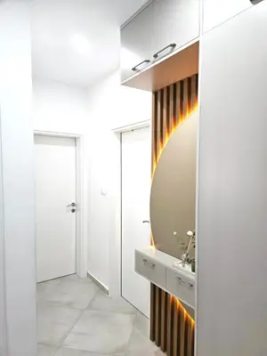 a bathroom with a sink and a mirror at V&L Apartman in Kravlja