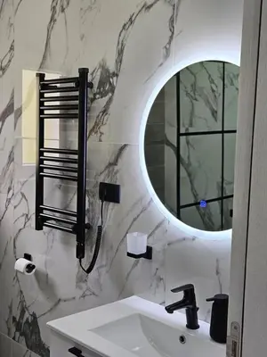 a bathroom with a sink and a mirror at V&L Apartman in Kravlja