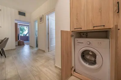 a laundry room with a washing machine in a house at Martin di Cattaro-Cosy Retreat Steps from Old Town in Kotor