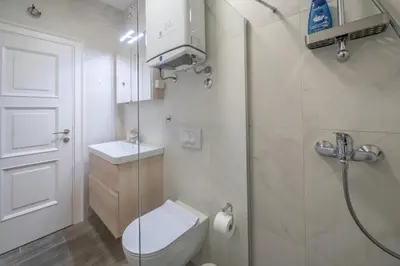 a small bathroom with a toilet and a shower at Martin di Cattaro-Cosy Retreat Steps from Old Town in Kotor