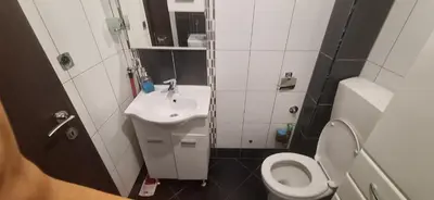 a small bathroom with a toilet and a sink at Apartman Budva in Budva