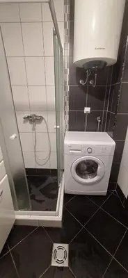 a washing machine in a bathroom with a shower at Apartman Budva in Budva