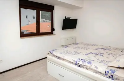a small bedroom with a bed and a window at Seaside Nest Budva -Cozy Retreat 3 min from Beach in Budva