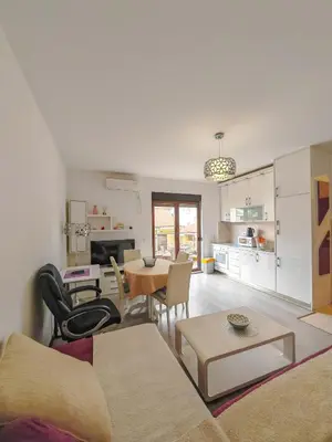 a living room with a couch and a table at Seaside Nest Budva -Cozy Retreat 3 min from Beach in Budva