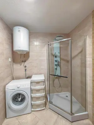 a bathroom with a washing machine and a washer at Seaside Nest Budva -Cozy Retreat 3 min from Beach in Budva