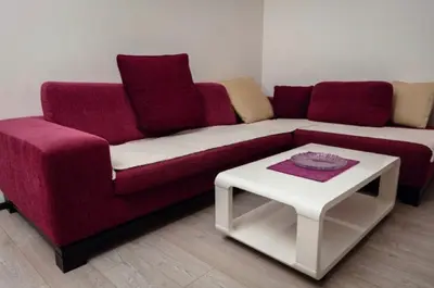 a living room with a red couch and a white table at Seaside Nest Budva -Cozy Retreat 3 min from Beach in Budva