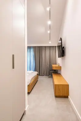 a bedroom with a bed and a desk and a window at Lucciola Boutique Rooms in Budva