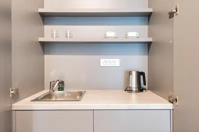 a kitchen counter with a sink and a coffee maker at Lucciola Boutique Rooms in Budva