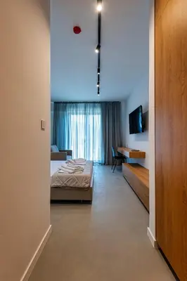 a bedroom with a bed and a tv in a room at Lucciola Boutique Rooms in Budva
