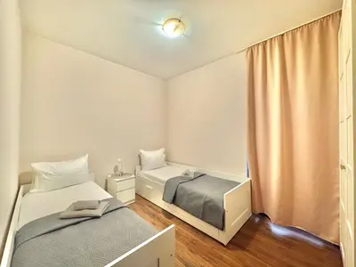 a small bedroom with two beds and a window at Two bedroom apartment Andrej in Budva
