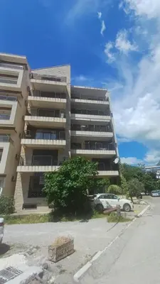 a tall building with a car parked in front of it at Two bedroom apartment Andrej in Budva