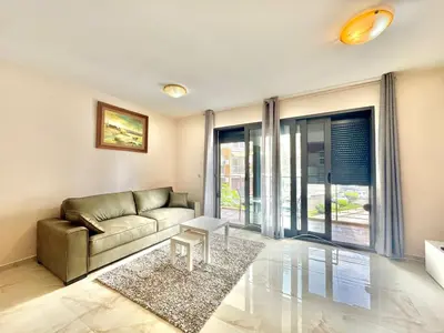 a living room with a couch and a table at Two bedroom apartment Andrej in Budva
