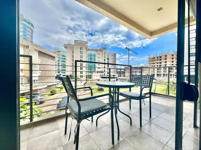 a balcony with a table and chairs and a view of a city at Two bedroom apartment Andrej in Budva