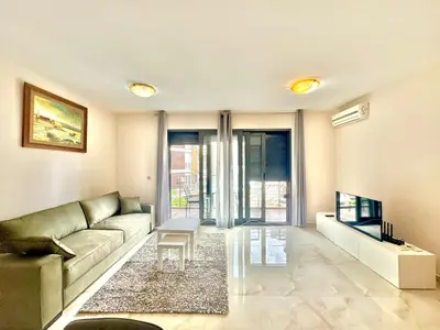 a living room with a couch and a tv at Two bedroom apartment Andrej in Budva