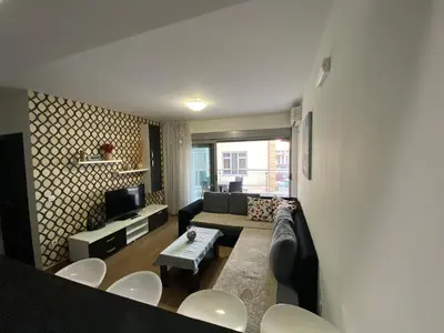 a living room with a couch and a table at Dragan Apartment in Budva