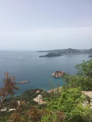 a view of a large body of water with islands at Apartments Sveti Stefan MNE in Sveti Stefan
