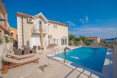 a villa with a swimming pool and a house at Villa Dragana in Budva