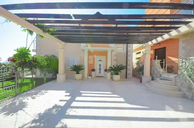 a building with a patio with potted plants on it at Villa Dragana in Budva