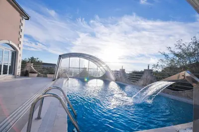 a pool with a water slide in a building at Villa Dragana in Budva