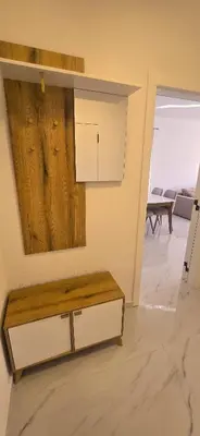 a living room with a table and a mirror at Apartmani Banović 3 - Ulcinj, Velika plaža in Ulcinj
