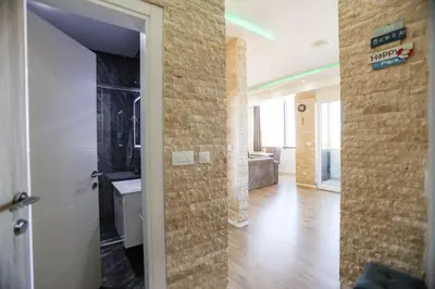 a room with a hallway with a door and a living room at Apartmani Stefan in Bar