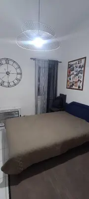 a bedroom with a large bed and a clock on the wall at Apartment Sutomore Cara Lazara in Sutomore