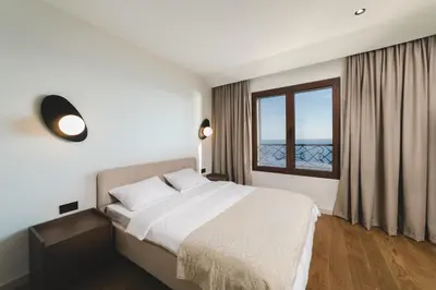 a bedroom with a large bed and a window at Villa Boscovich in Katun