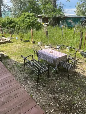 a table and two chairs and a table and a table and chairs at Velicanka hostel 2 in Kravlja