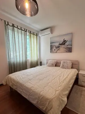 a bedroom with a large bed and a large window at Alex Apartment Petrovac in Petrovac na Moru