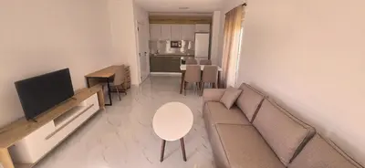 a living room with a couch and a table at Apartmani Banović 2 - Ulcinj, Velika plaža in Ulcinj