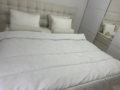 a large white bed with white sheets and pillows at Villa Zaljevo in Bar
