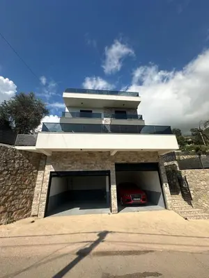 a building with a garage with a car in it at Villa Zaljevo in Bar