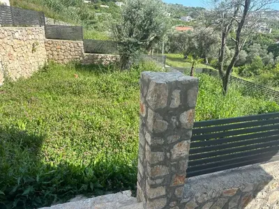 a park bench sitting next to a field of grass at Villa Zaljevo in Bar