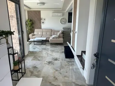 a living room with a couch and a table at Villa Zaljevo in Bar