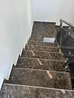 a staircase with brown marble floor and metal railing at Villa Zaljevo in Bar
