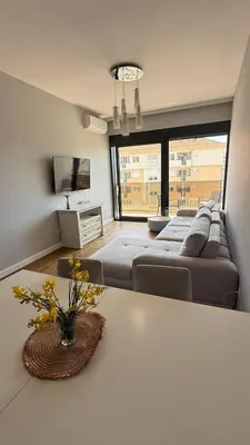 a living room with a couch and a table at Soho Stay in Bar