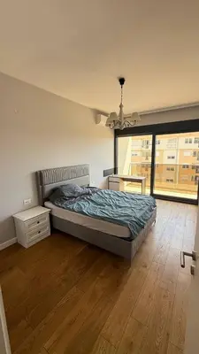 a bedroom with a bed and a large window at Soho Stay in Bar