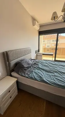 a bedroom with a large bed with a window at Soho Stay in Bar