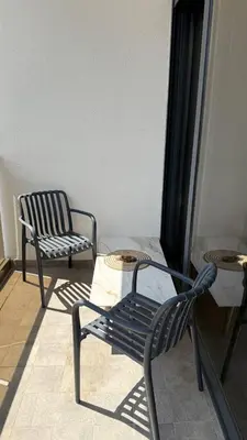 two chairs and a table in a room at Soho Stay in Bar