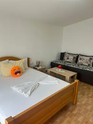 a bedroom with a bed with a pumpkin on it at Halili Apartments in Ulcinj