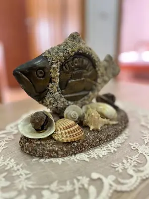 a figurine of a dog with shells on a table at Halili Apartments in Ulcinj