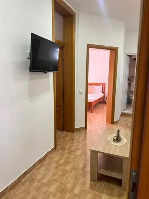 a living room with a flat screen tv on a wall at Halili Apartments in Ulcinj