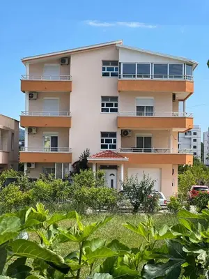 an apartment building with plants in front of it at Halili Apartments in Ulcinj