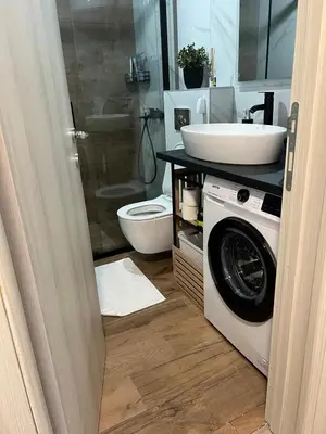 a bathroom with a washing machine and a sink at Utjeha Hills with Pool in Bar