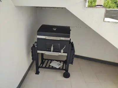a barbecue cart sitting under a stair case at Utjeha Hills with Pool in Bar