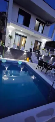 a house with a swimming pool in front of a house at Utjeha Hills with Pool in Bar