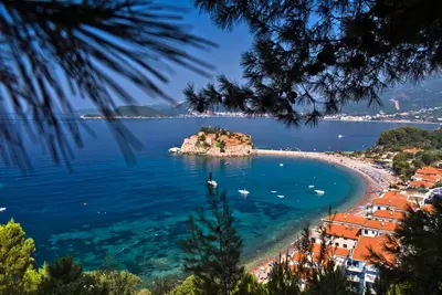 a beach with a small island in the water at Summer Nest Studio in Becici in Becici