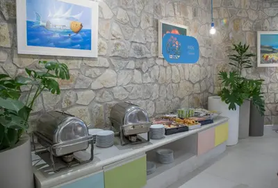 a buffet line with food in a restaurant at Hotel Slovenska Plaza in Budva