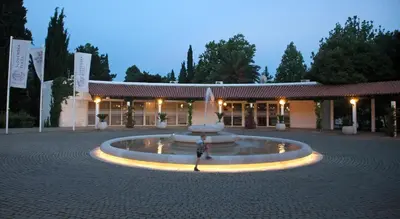 a fountain in a courtyard in front of a building at Hotel Slovenska Plaza in Budva