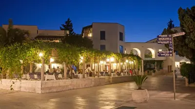 a street sign in front of a building at night at Hotel Slovenska Plaza in Budva